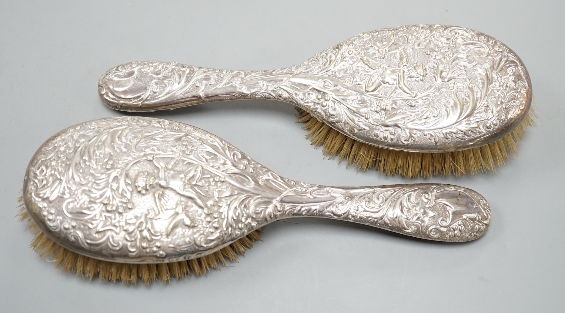 A pair of late Victorian repousse silver mounted hairbrushes, Birmingham, 1893.